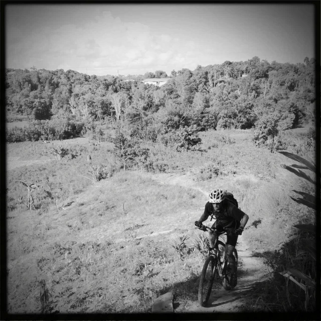 a person riding a bicycle on a dirt trail