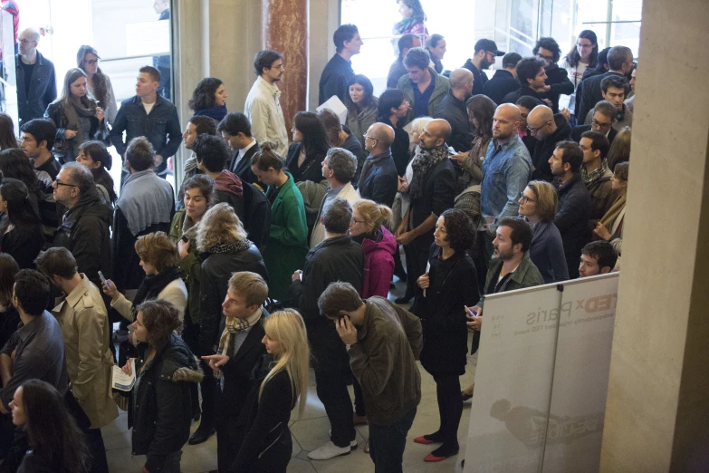 a group of people crowded together outside in an airport