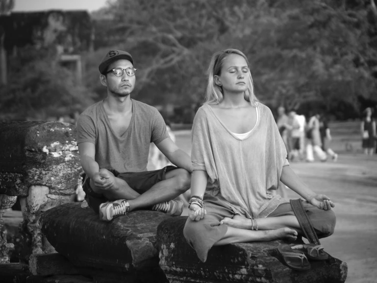 a black and white po shows a man and woman meditating