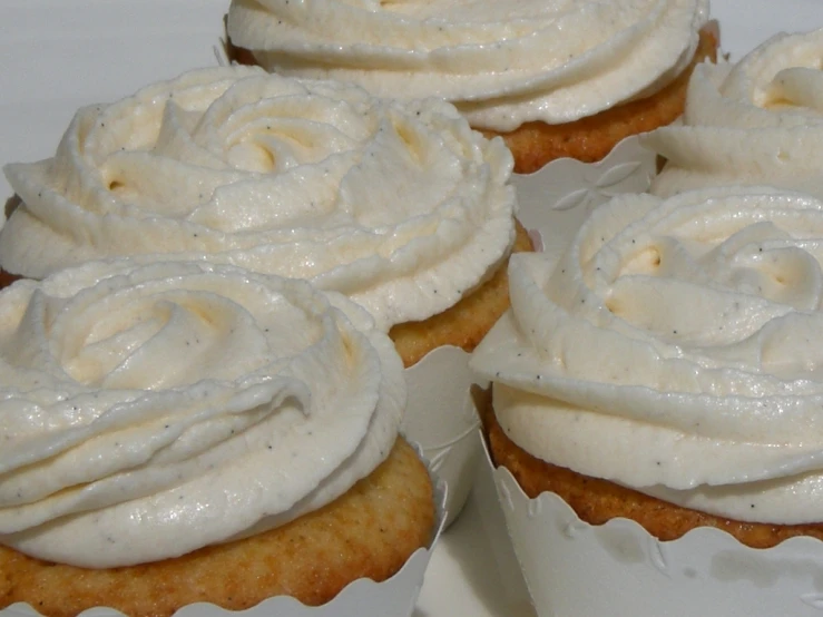 a group of cup cakes with frosting on top