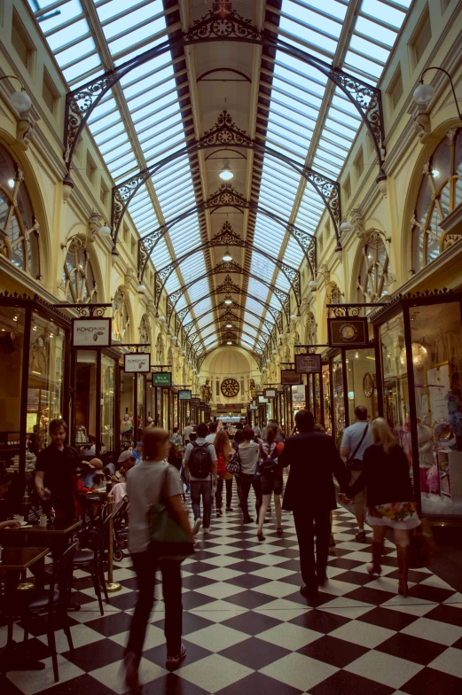 the ceiling in this building is filled with people and a large sky light