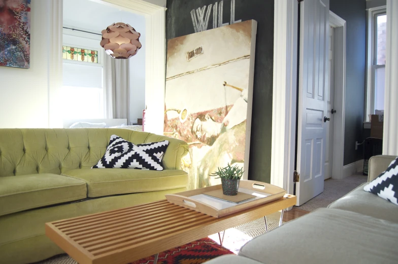 living room scene with green couch and coffee table