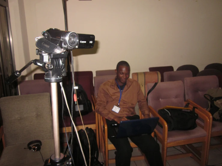 an image of a man on camera with chair