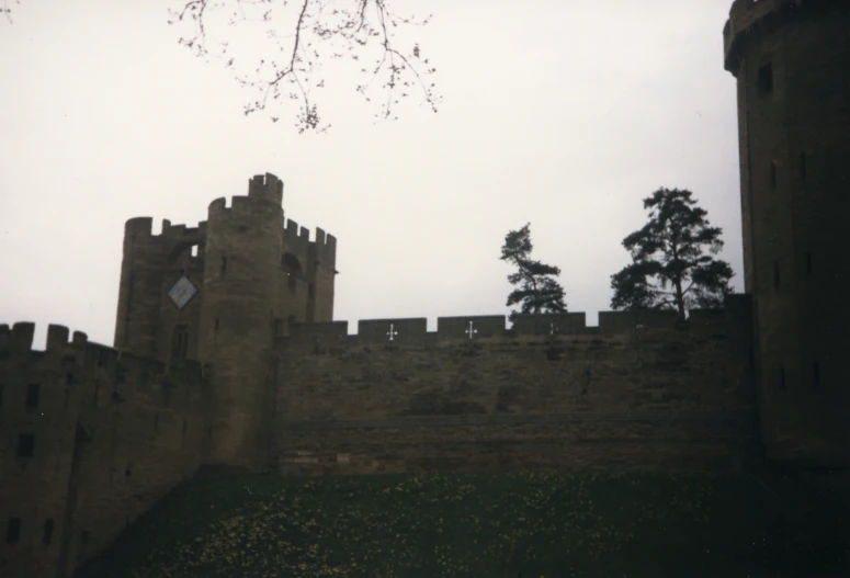 a stone castle with a small clock on the tower