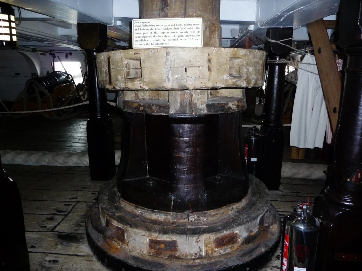 a very large iron clock sitting on top of a metal stand