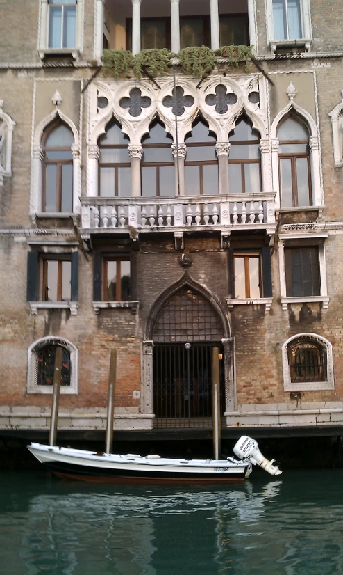 a boat docked in front of a large building