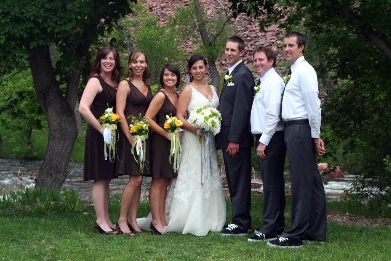 the groom and bridesmaids are posing for a po in their wedding attire