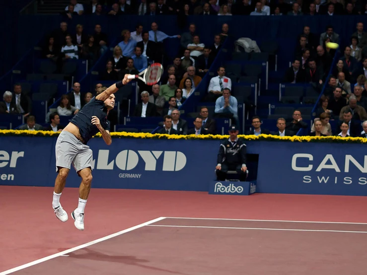 a tennis player in mid air during a tennis match