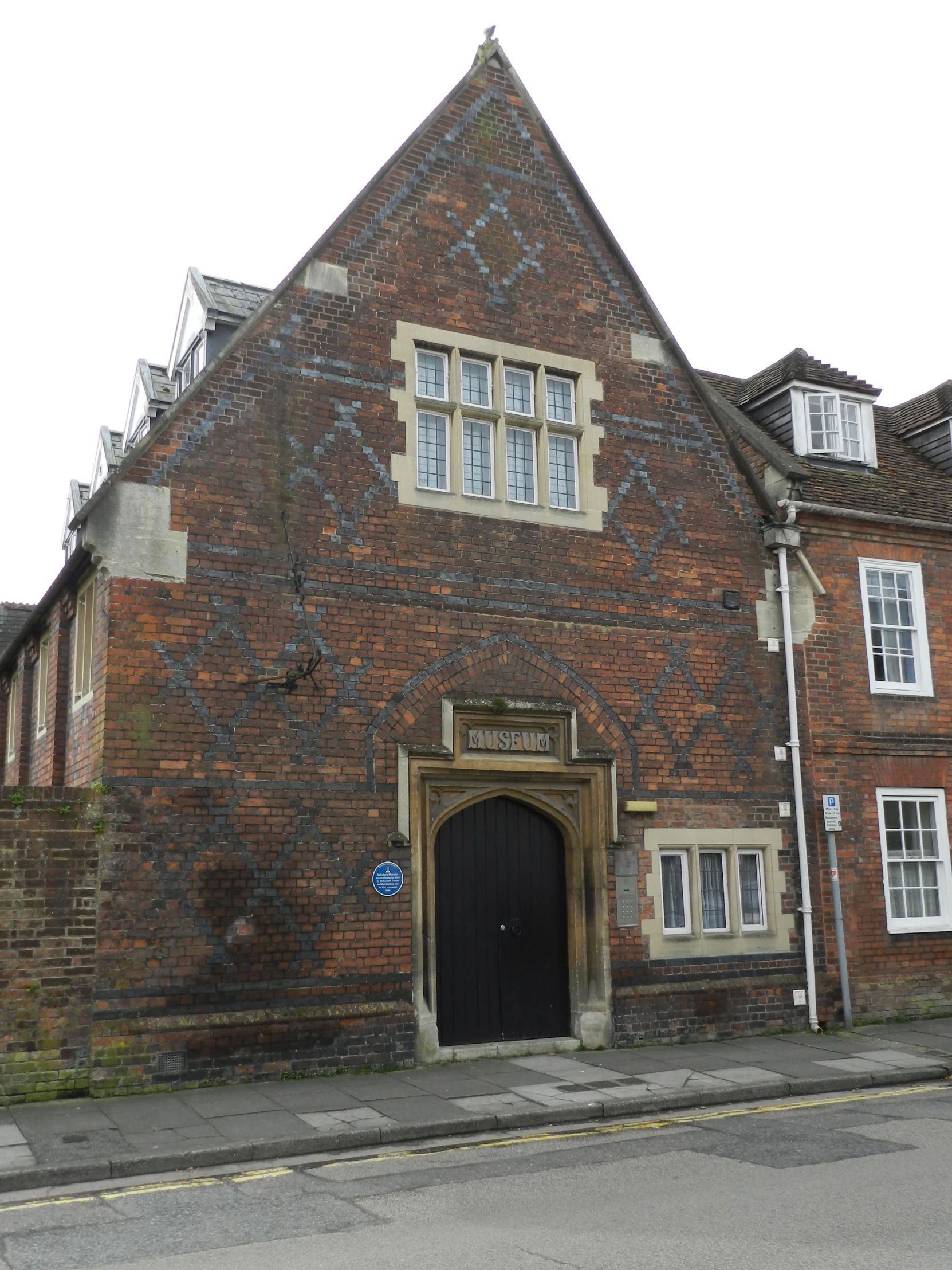 an old building with a lot of windows and a black door