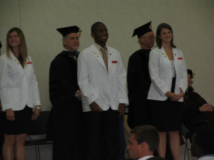 a group of people standing in line for graduation