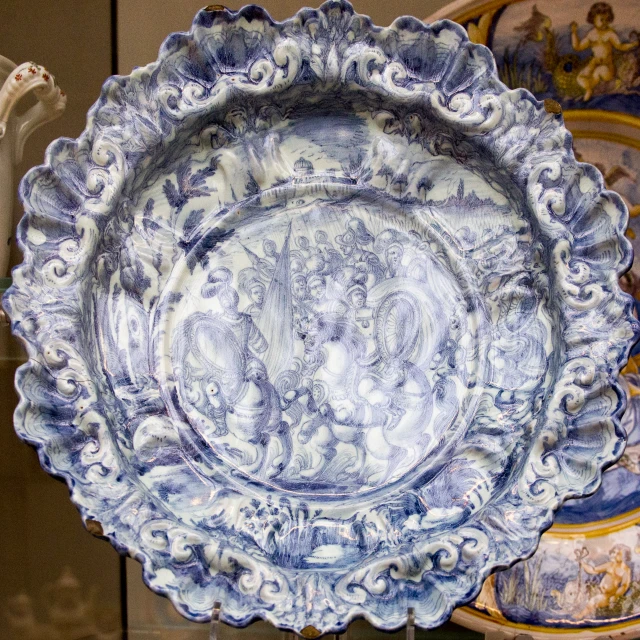 a large decorative blue dish sitting next to other plates