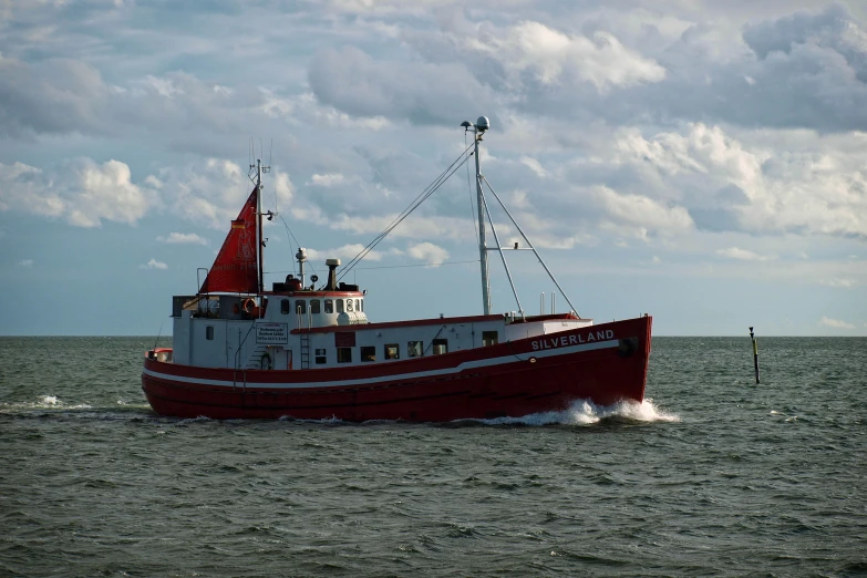 the red and white boat is out in the water