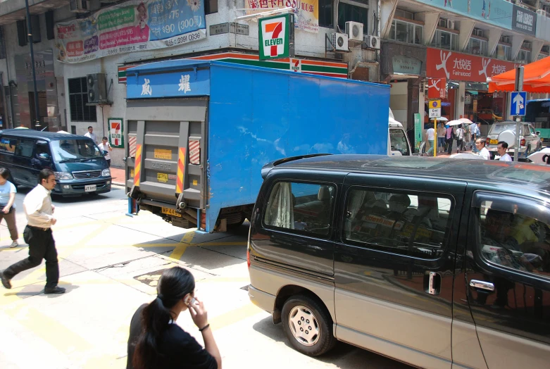 a silver van sitting next to a blue truck