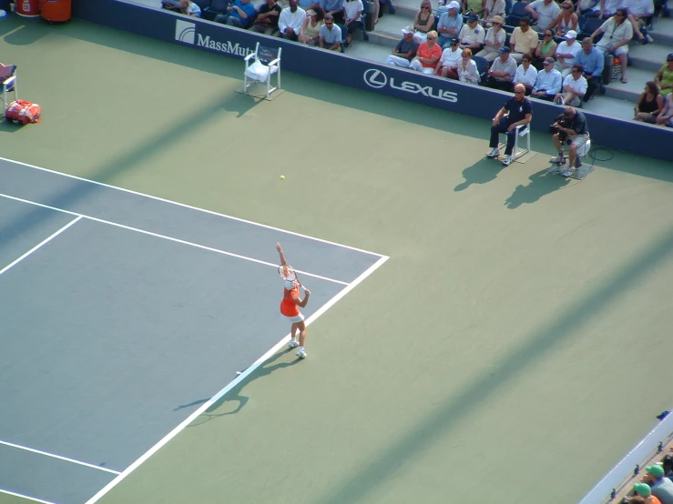 a woman serves the ball during a tennis match