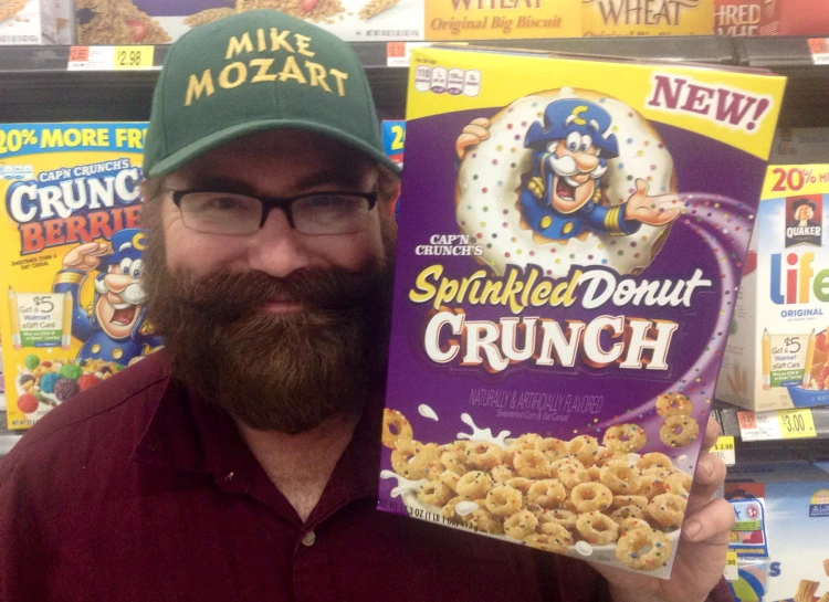 the man is holding up a boxed cereal with an evil hat