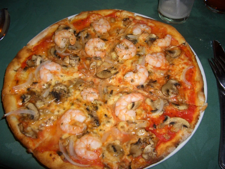 the seafood pizza with mushrooms is ready to be eaten