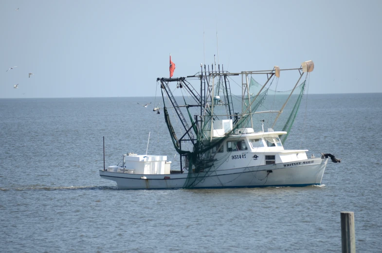 a large fishing boat floating on top of the ocean