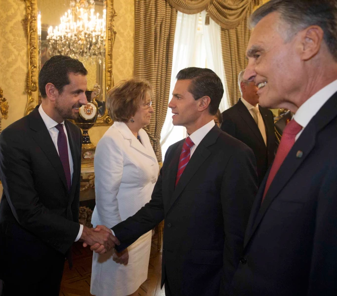 some people wearing suits and tie standing together