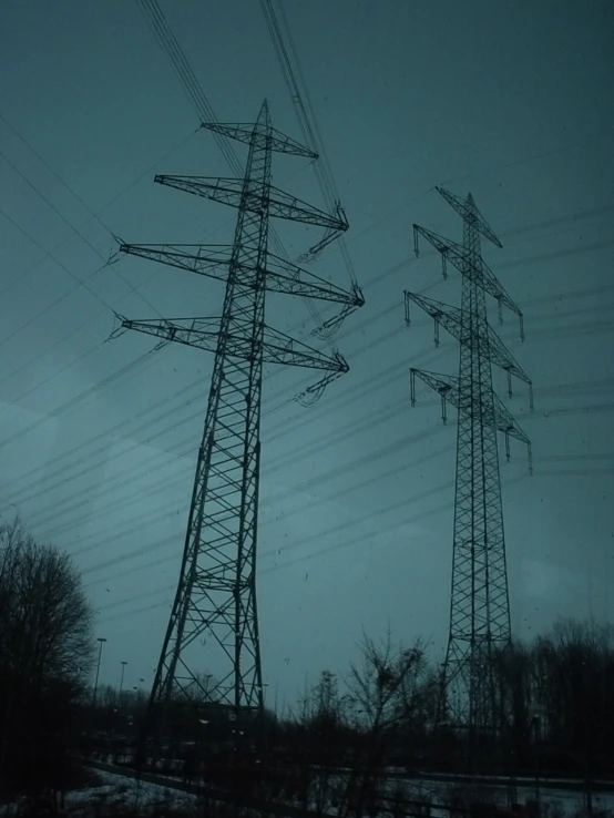 three power poles in the dark by a field