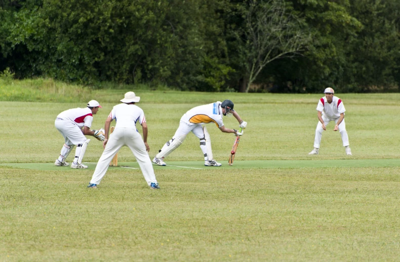 some men standing on a field playing ball