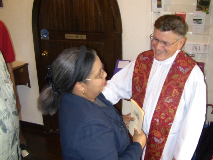 two people in church attire standing together talking