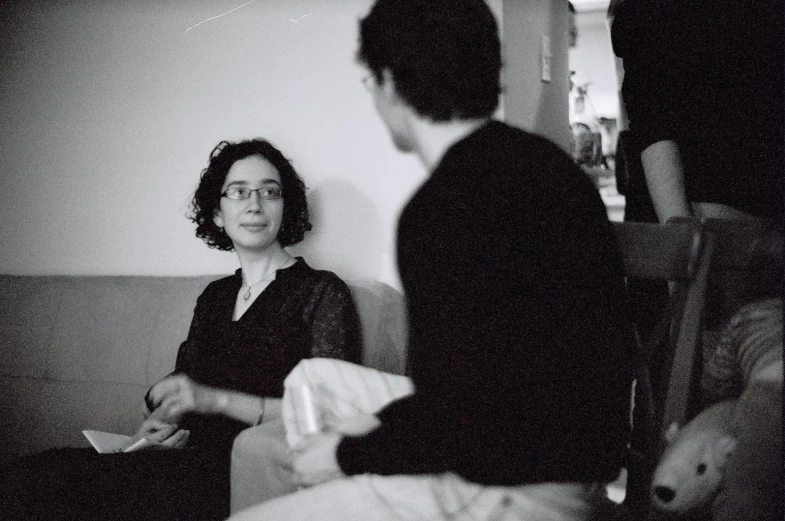 black and white pograph of a woman sitting on a couch