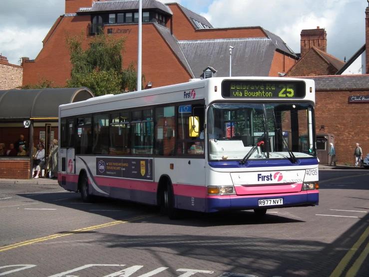 a commuter bus drives down the road in an european country