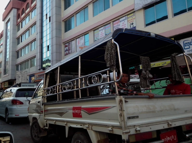 the truck is traveling down the busy city street