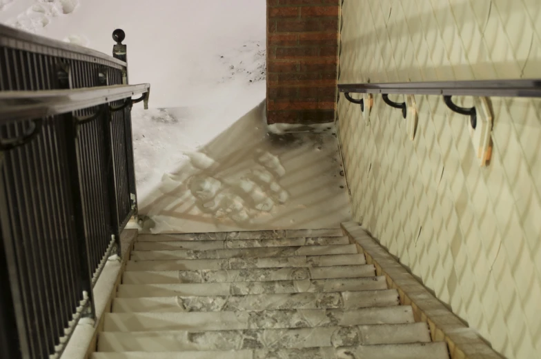 snow falls down an alleyway and steps