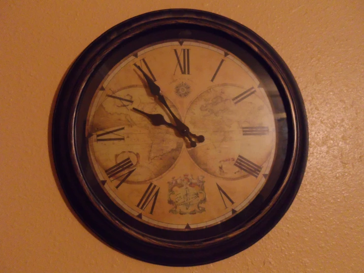 a clock with black case hanging on the wall