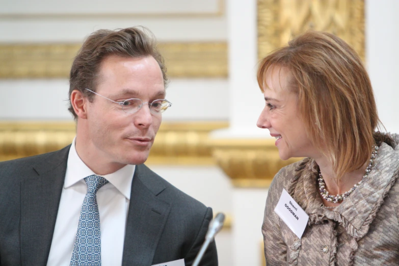 the couple are looking at each other in conversation