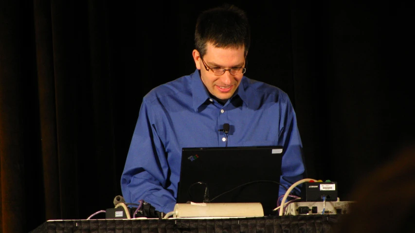 the man is using a laptop at a table