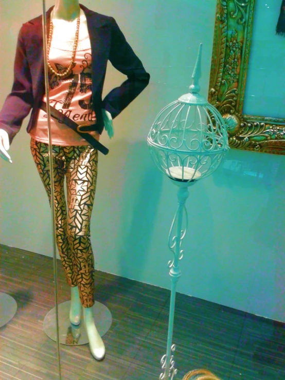 mannequin dressed in a pink shirt with chains and jeans