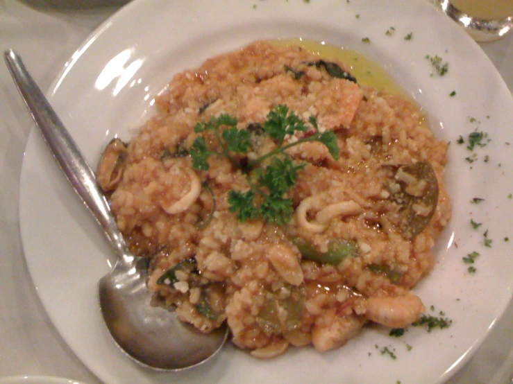 food with shrimp, mushrooms, and other foods on a white plate