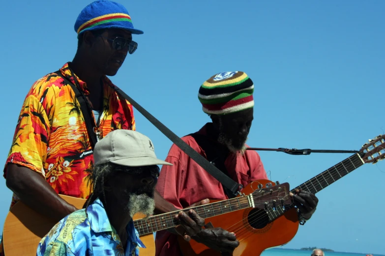 two men, one with a guitar and another with an acoustic instrument