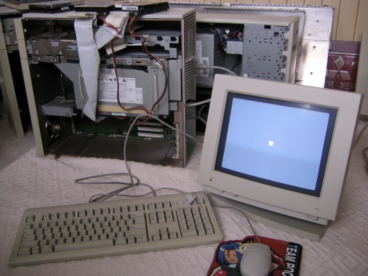 a mac computer sitting in front of a broken screen