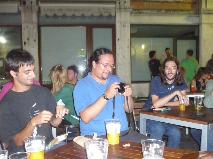 some people sitting at a table with beers and beer