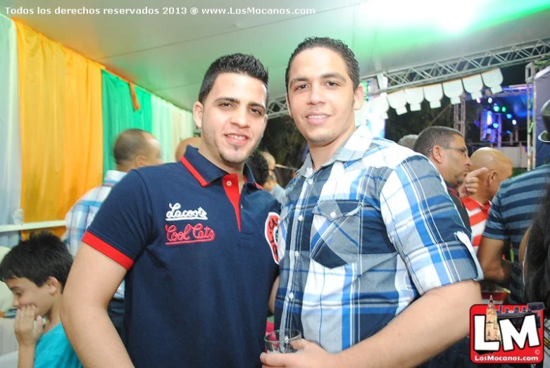 two young men standing together at an event