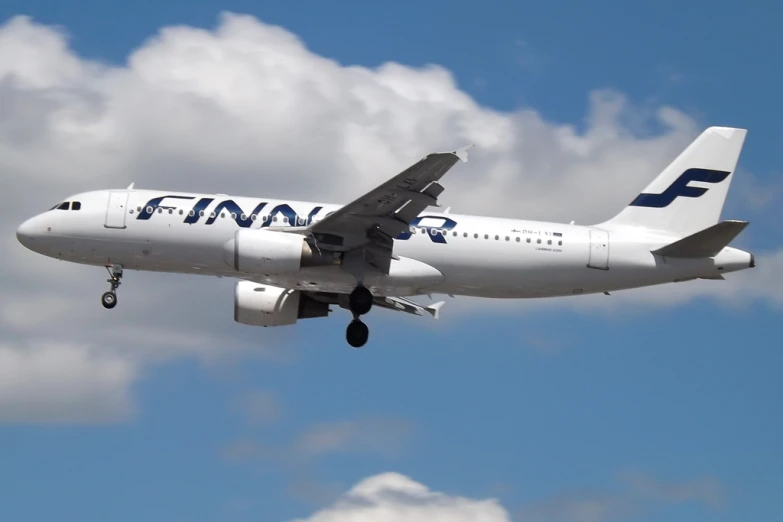 a large jet flying through a blue sky