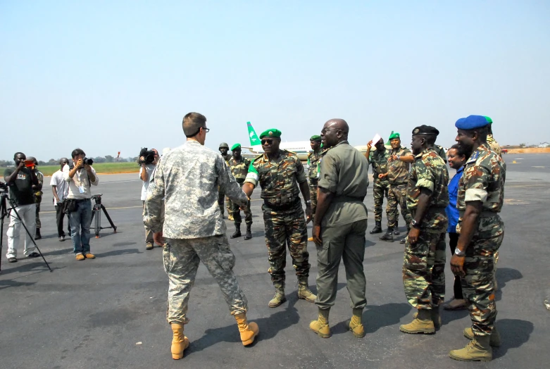 some men wearing hats and military uniforms