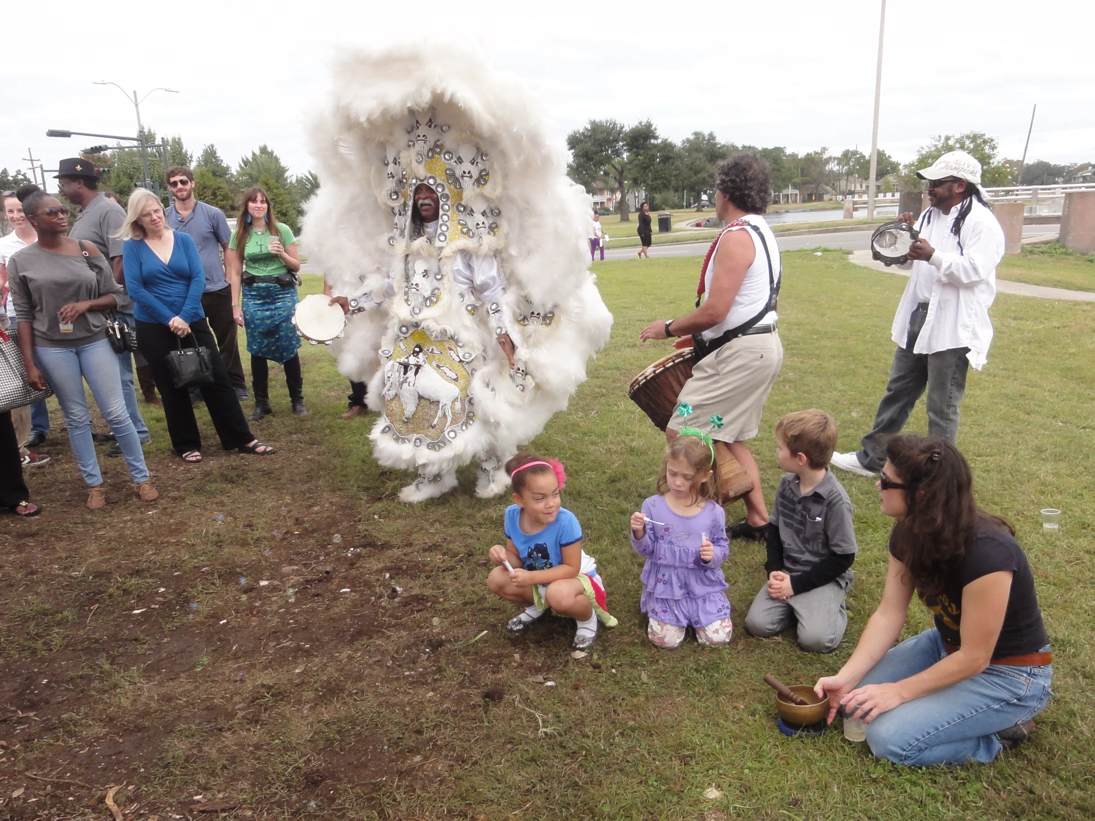 the woman in costume is sitting by some people