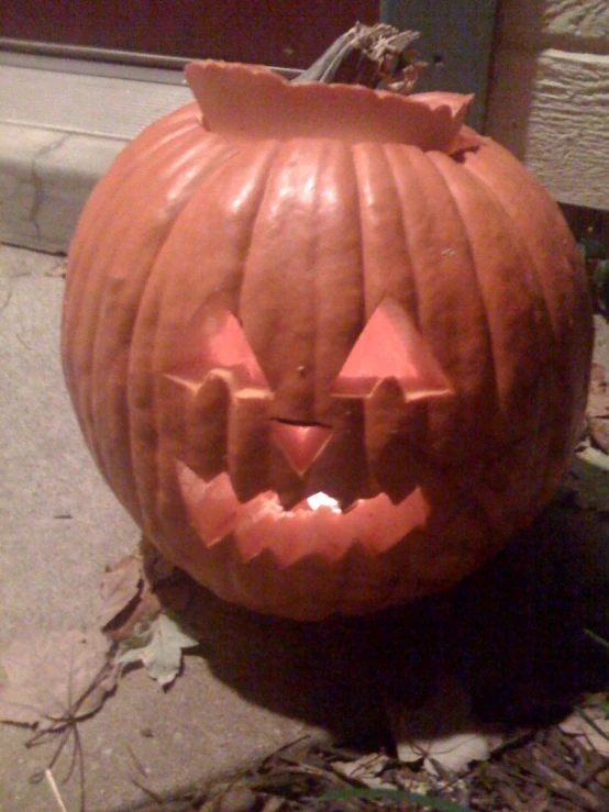 a carved pumpkin sits in front of a door