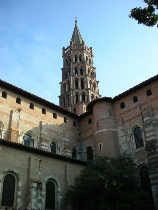 a large cathedral towering over a city surrounded by greenery