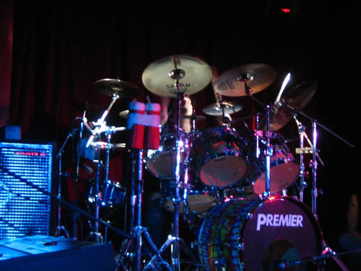 there is a drum set on stage with a musical keyboard in the foreground