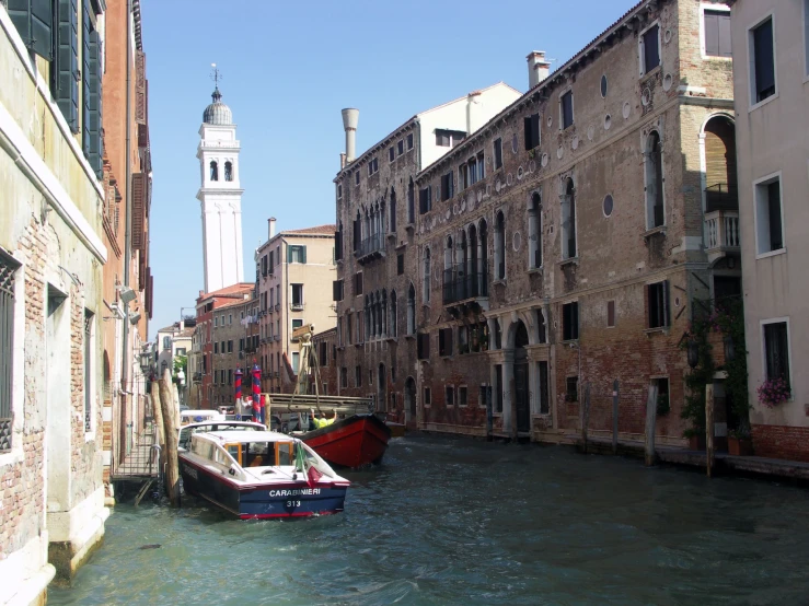 a bunch of boats in the water and some buildings