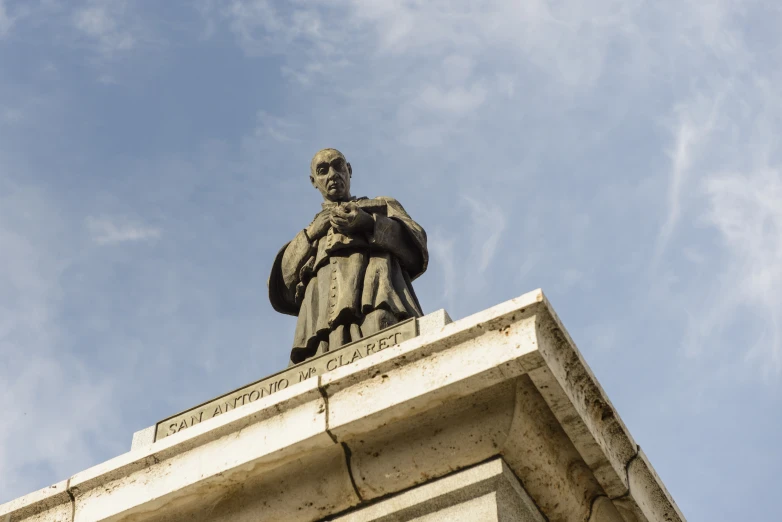 a statue on top of a building with a sky background