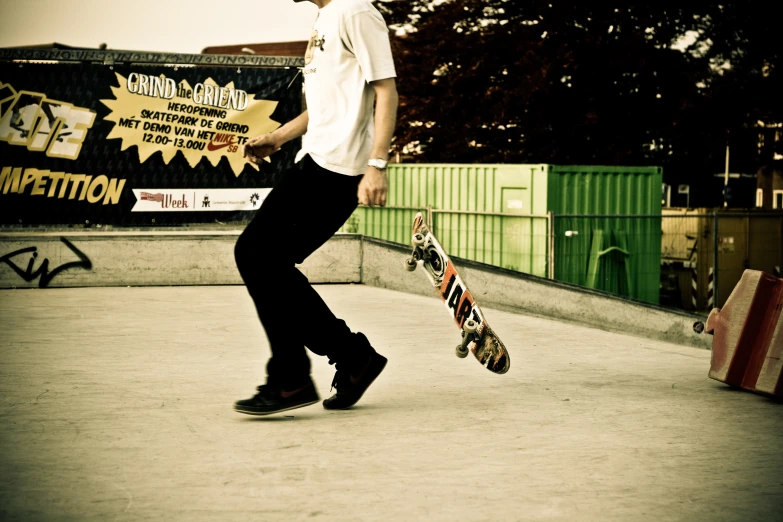 a boy riding on top of a skateboard at a skate park
