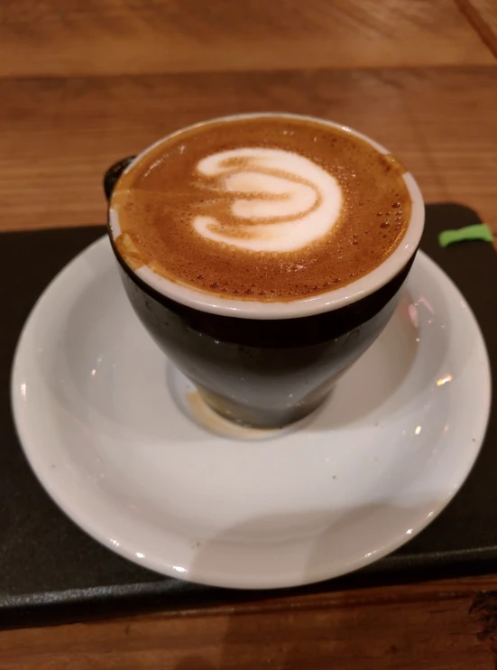 a cup with latte art on the top