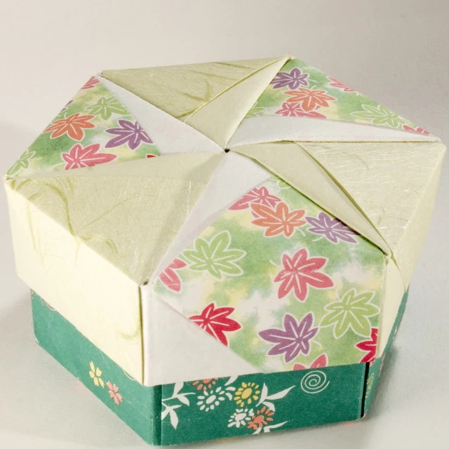 a paper block made into an origami flower arrangement