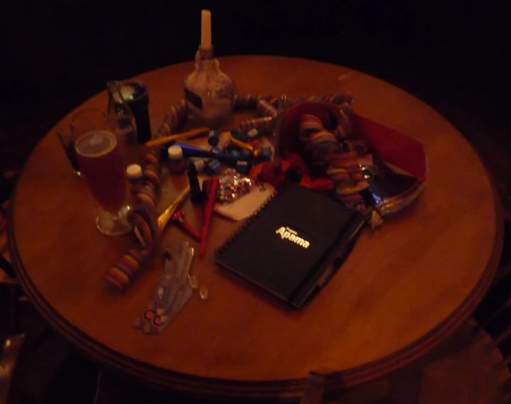 a table topped with lots of objects and writing utensils